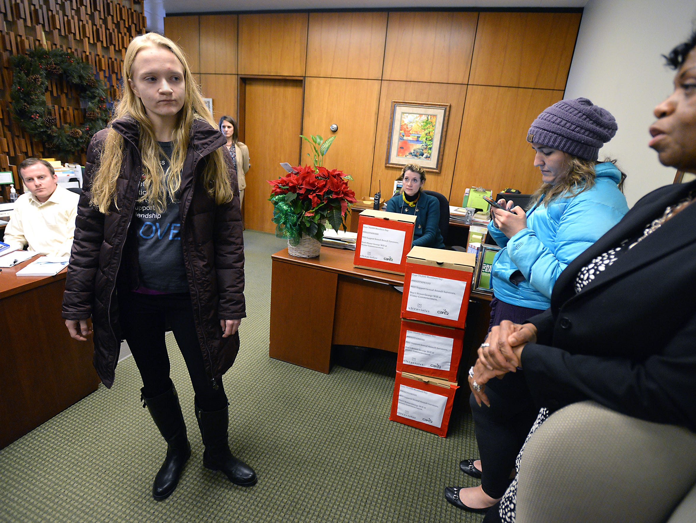 MSU student Emily Kollaritsch, standing left, speaks