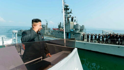 An undated file picture released by the Rodong Sinmun, the newspaper of the ruling North Korean Workers Party, shows North Korean leader Kim Jong Un saluting to military servicemen on a Navy ship, somewhere in North Korean waters.