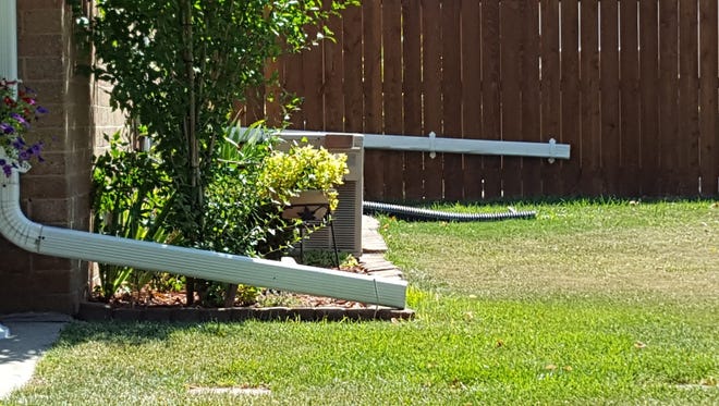 The location of downspouts and permeable surfaces on lots like these in a Milwaukee neighborhood can have a major impact on how much storm water is absorbed into the ground.