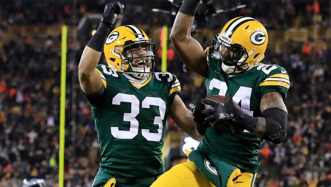 Green Bay Packers cornerback Quinten Rollins (24) and strong safety Micah Hyde (33) celebrate after Rollins intercepted a pass as the Green Bay Packers host the Seattle Seahawks at Lambeau Field.