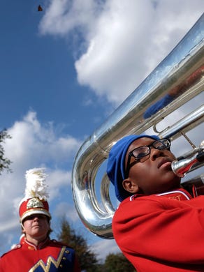 West High School's Marching Band's Kaleb Kirkland, right, carries his tuba to their performance while being followed by band member Brandon Walker during the Farragut Admirals' Cup Invitational at Farragut High School, Saturday, October 18, 2014 in Knoxville, Tenn. 