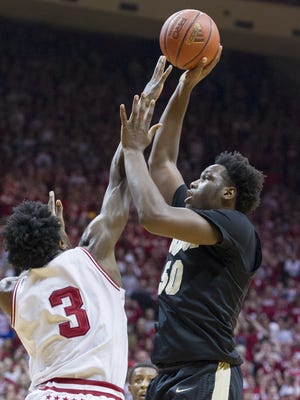 Purdue Boilermakers forward Caleb Swanigan (50) puts up a shot over the defense of Indiana Hoosiers forward OG Anunoby (3) during an NCAA men's college basketball game at Indiana University's Assembly Hall in Bloomington, Ind., Saturday, Feb. 20, 2016. IU won, 77-73.