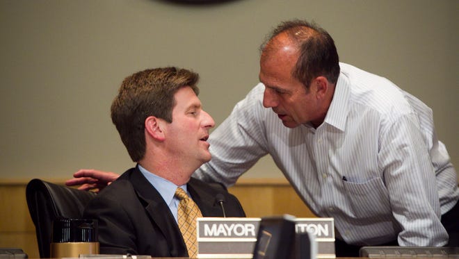 Phoenix Mayor Greg Stanton( left) talks to City Council member Sal Diciccio during an April 4, 2012, council meeting.