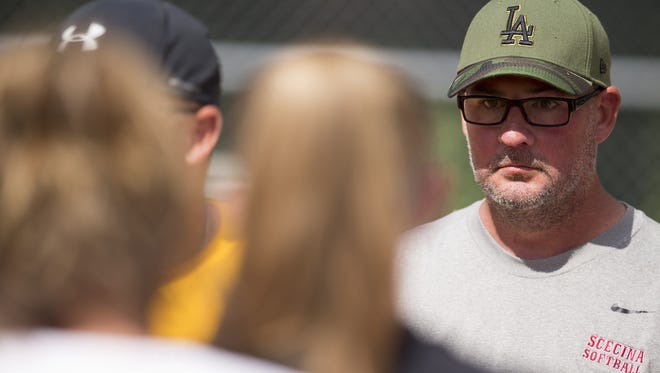 Cory Gray, who suffered a stroke last year, oversees softball practice for Scecina Memorial High School, which looks toward Saturday's 2A state title game.