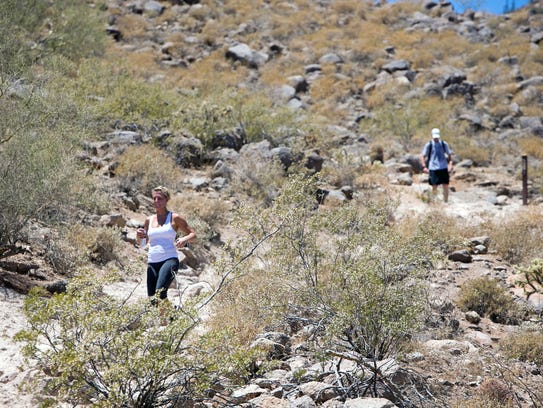 Hikers make their way down the Cholla Trail at Camelback