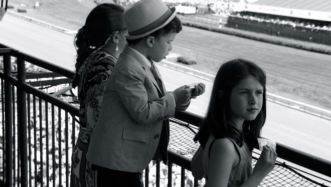 Linda Bruckheimer's photo "Rookie Bookie," part of the show "Spotted at the Racetrack" at Revelry Gallery.