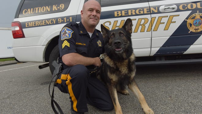 Sgt. Timothy Scannell, the Bergen County sheriff's officer in charge of the county's K-9 unit, with his dog, Odin.