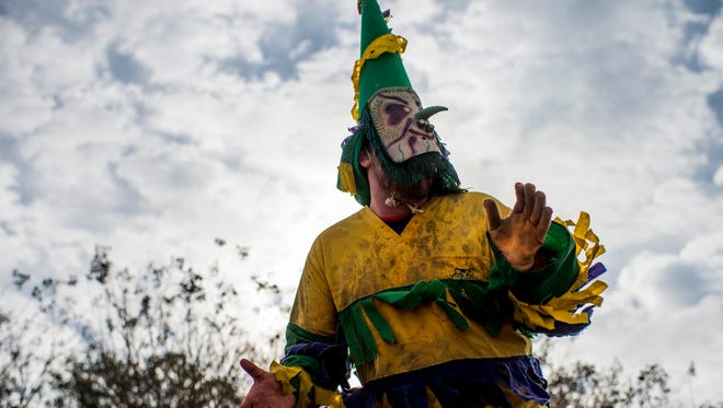Costumed horsemen, known as Mardi Gras, travel through the streets during the Courir de Mardi Gras in Mamou, La., Tuesday, Feb. 17, 2015. Participants travel from home to home, begging homeowners for ingredients to create a large community gumbo and chasing loose chickens as part of the holiday tradition.