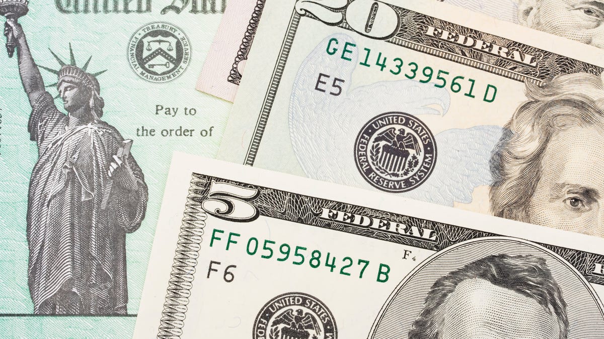 Money on top of US Treasury check.