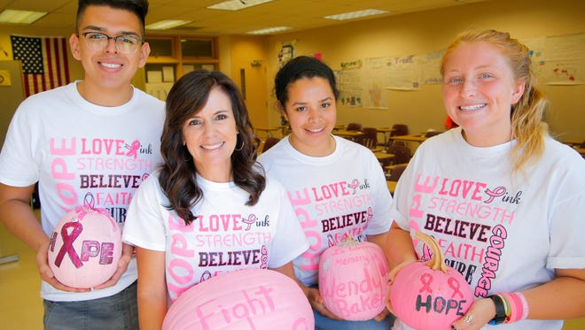Everett Alvarez High School Interact Club local community service project chairperson Andrew Tamez, advisor Jodie Kaminskis, vice president Yazmin Ochoa and president Rachel Finkelstein show the shirts and pumpkins they'll be selling Friday at the Hope Football Game.