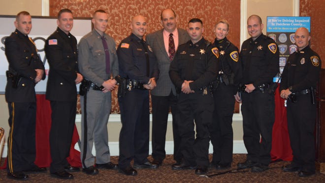 The Dutchess County STOP-DWI Planning Board honored eight law enforcement officers as “TOP COPS” at the 22nd Annual Dutchess County STOP-DWI Program’s Law Enforcement Awards Luncheon. From left to right are Richard Sisilli, Travis Sterritt, Edward Reiser, Justin Felicello, Dutchess County STOP-DWI Coordinator William C. Johnson, Stephen Sasoni, Dawn Bonds, Evan Traudt, Michael Veeder.