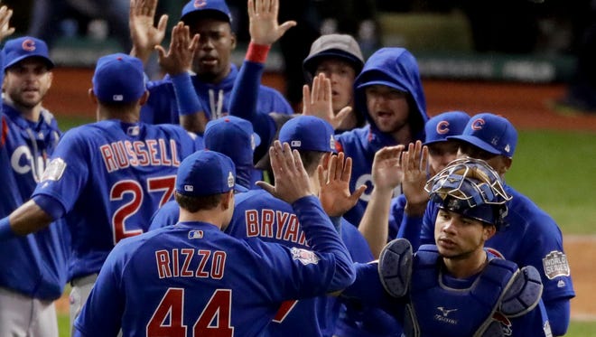 Members of the Chicago Cubs celebrate their win against the Cleveland Indians after Game 2 of the Major League Baseball World Series Wednesday, Oct. 26, 2016, in Cleveland. The Cubs won 5-1 to tie the series 1-1.