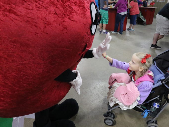 Avery Fregien of Embarass high fives the mascot of