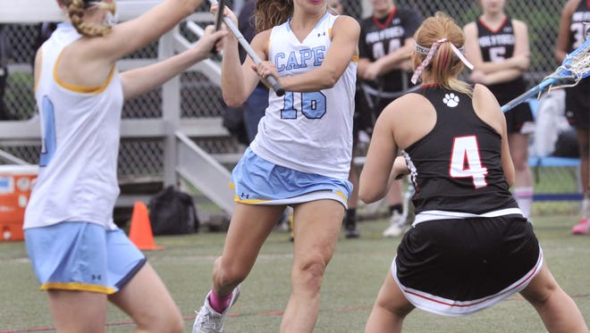 Alia Marshall of Cape Henlopen (middle) passes to Lindsay Monigle asCloe Markow of Polytech defends on April 26. Eight-time defending state champion Cape will again be the favorite when the DIAA Girls Lacrosse Tournament begins Thursday.