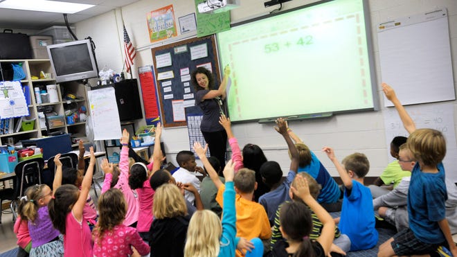 Third-grade teacher Melissa Grieshober teaches a math lesson at Silver Lake Elementary School in Middletown, Del. Sometime in elementary school, you quit counting your fingers and just know the answer. Now scientists have put youngsters into brain scanners to find out why, and watched how the brain reorganizes itself as kids learn math.