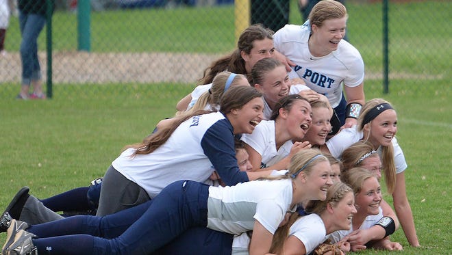 Bay Port softball players celebrate their 1-0 shutout win over Ashwaubenon in a WIAA Division 1 sectional final game at Pioneer Park on June 4.