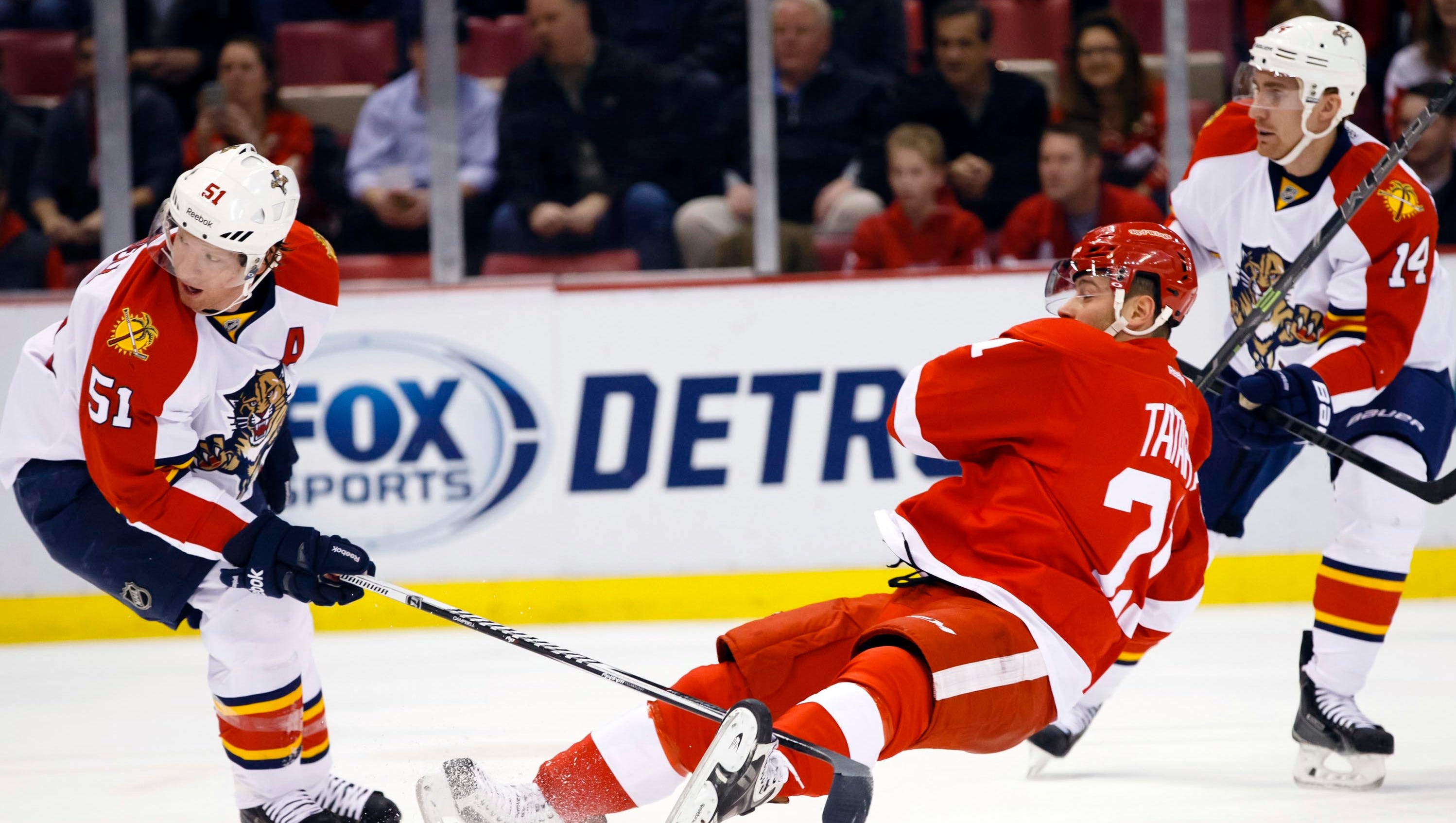 Red Wings left wing Tomas Tatar shoots while being defended by Panthers defenseman Brian Campbell in the first period.