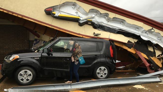 Mandy Supple, 24, of Forest Hill was in her car at Pizza Hut on South MacArthur Drive when a piece of the building fell on her car during a storm Monday.
