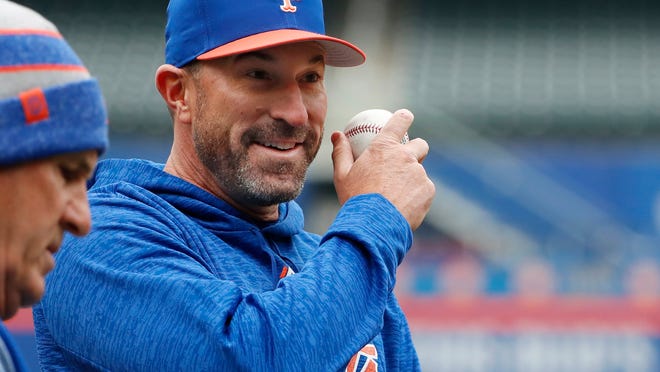 New York Mets manager Mickey Callaway, right, talks with third base coach Glenn Sherlock during a team workout at Citi Field, Wednesday, March 28, 2018, in New York. The team faces the St. Louis Cardinals at home for opening day Thursday. (AP Photo/Kathy Willens)