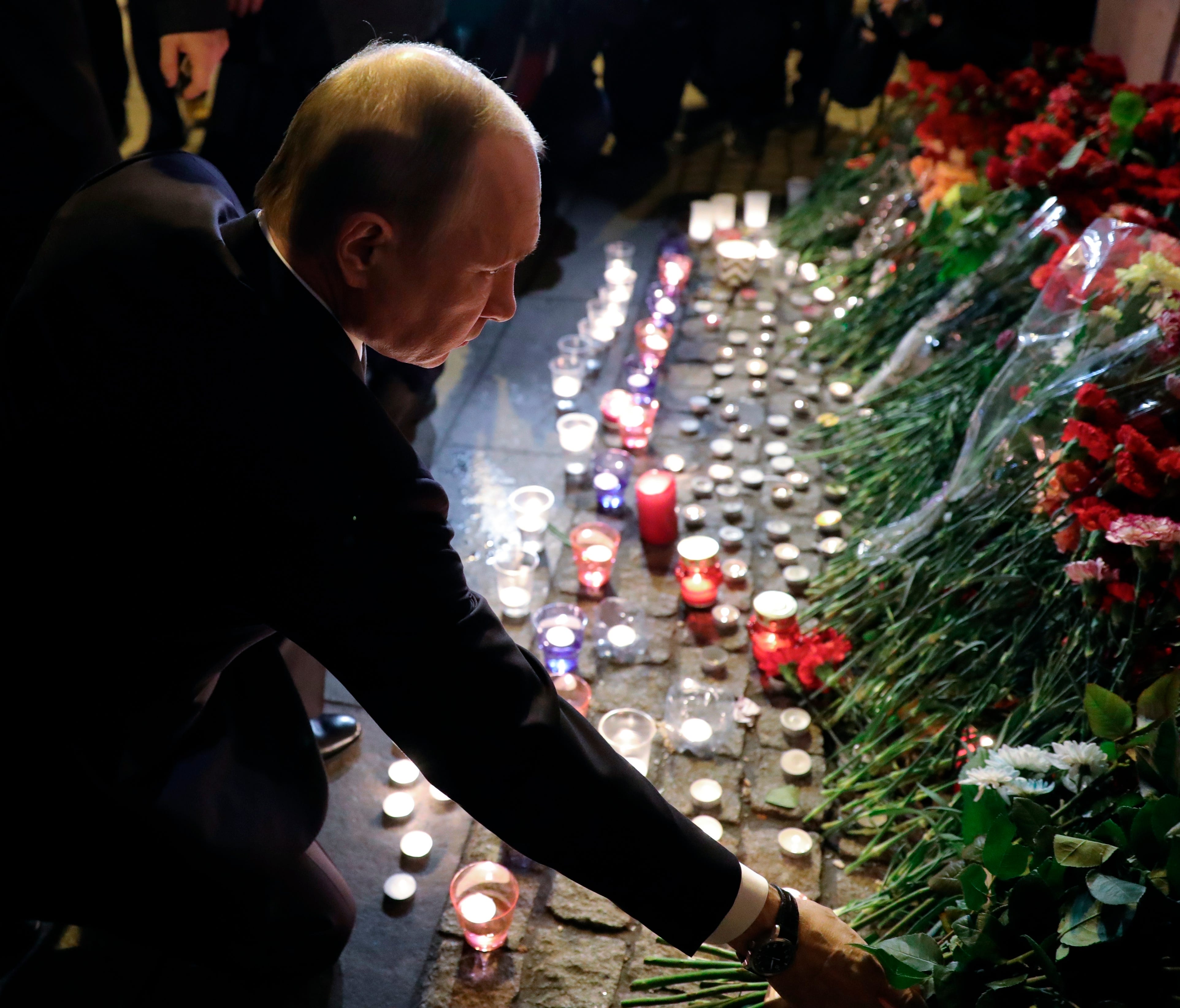 Russian President Vladimir Putin lays flowers at a place near the Tekhnologichesky Institut subway station in St.Petersburg, Russia, Monday, April 3, 2017.