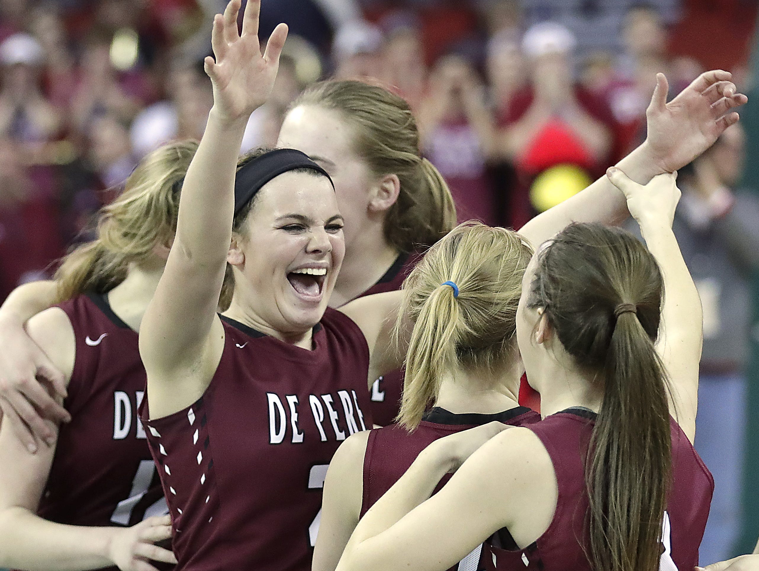 De Pere Annie Schneider cheers as the Redbirds win in overtime against Middleton in a WIAA Division 1 Girls State Basketball semifinal at the Resch Center in Ashwaubenon Friday.