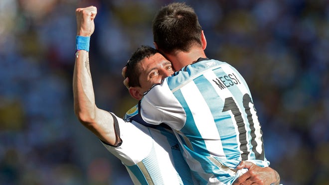 
Argentina’s Lionel Messi (right) celebrates with Angel di Maria after di Maria scored the winning goal in extra time in a World Cup round of 16 match against Switzerland at the Itaquerao Stadium in Sao Paulo, Brazil, on Tuesday. Argentina defeated Switzerland 1-0 to move on to the quarterfinals. 
