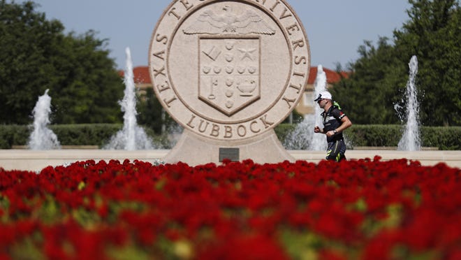 A participant runs through campus during the Ironman 70.3 Lubbock, Sunday, June 30, 2019, at Texas Tech in Lubbock, Texas.