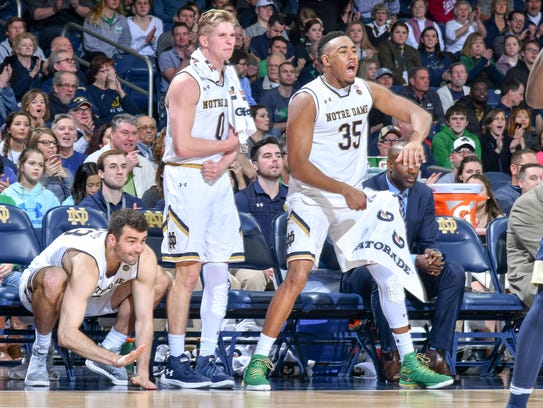 Notre Dame forward John Mooney (33), guard Rex Pflueger (0) and forward Bonzie Colson (35) react in the second half against Pittsburgh at Purcell Pavilion.