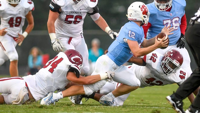 Crockett County's Colby Pruitt and Josh Owens try to sack USJ's Cody Smith (12) in a game earlier this season. Smith threw the ball away only for it to be intercepted.