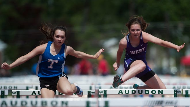 Athletes compete in the 100 meter high hurdles Saturday, May 14 in Haddon Township.