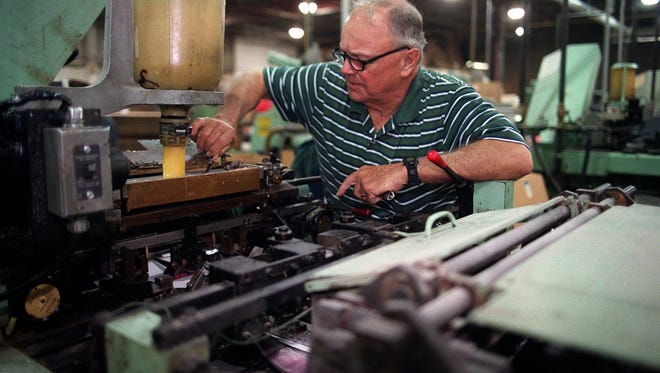 Leader Paper Products Co. Chairman Ralph Wilke adjusts some equipment at the company's Walker's Point facility in this 2001 photo. Leader has bought a building near Mitchell International Airport where it plans to relocate and expand.