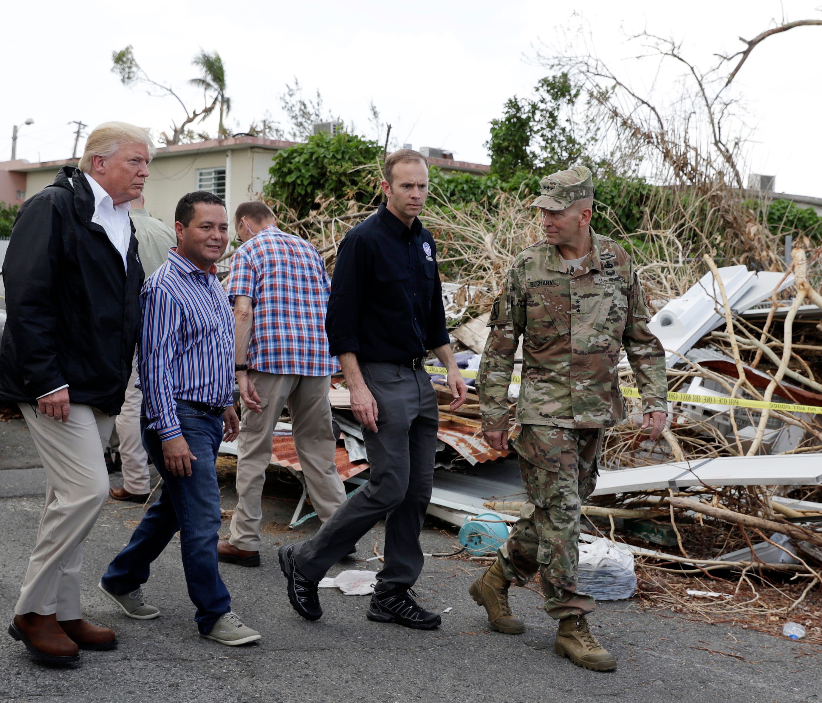 President Trump walks with FEMA administrator Brock Long, second from right, and Lt. Gen. Jeff Buchanan, right as he tours an area affected by Hurricane Maria in Guaynabo, Puerto Rico, on Oct. 3, 2017.