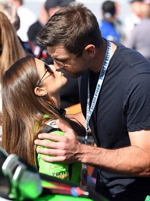 Danica Patrick and Aaron Rodgers share a kiss prior to the Daytona 500 in 2018.