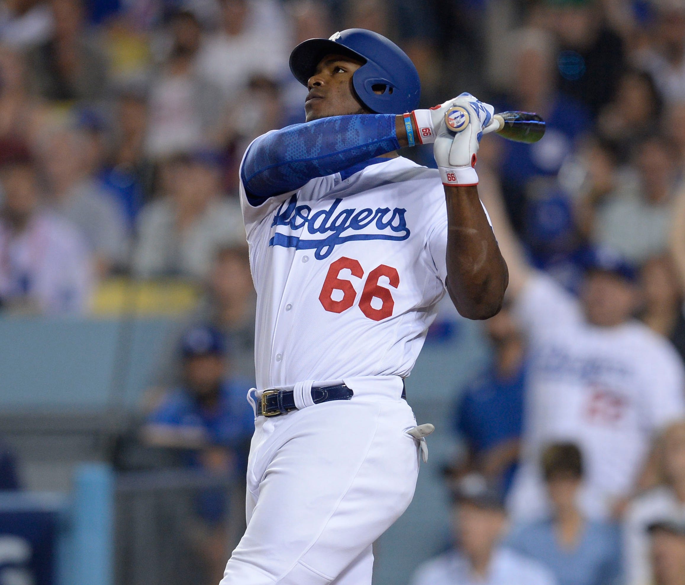 Yasiel Puig watches his seventh-inning homer leave the yard.