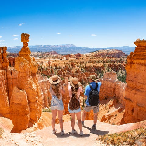 Three people in hats standing in Bryce Canyon...