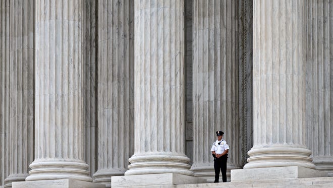 A police officer stands guard outside Supreme Court.