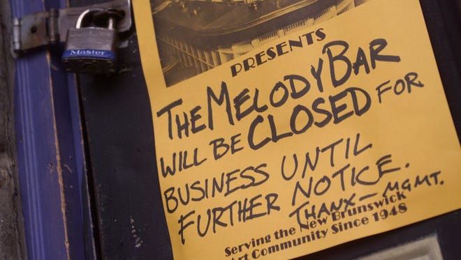 A sign hangs on the padlocked front door of the Melody Bar on Thursday March 22, 2001.