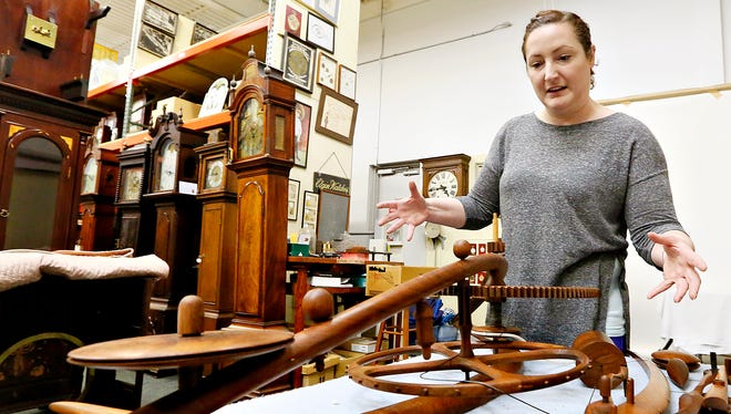 National Watch and Clock Museum Curator of Collections Kim Jovinelli shows the pieces of a sculpted clock in the collection storage area of the museum in Columbia, Thursday, June 2, 2016. The clock, made of walnut, had been on display at the museum since 1994, until a patron touched the clock on Tuesday, May 31, 2016, knocking it to floor. The museum is choosing to use the mishap as an educational moment and encouraging museum-goers to look but not touch. Dawn J. Sagert photo