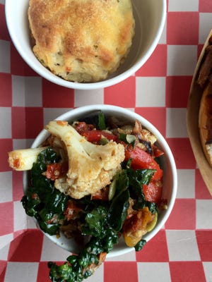 Kale and cauliflower salad and buttermilk biscuits are side dishes at Pik Nik in Tarrytown.