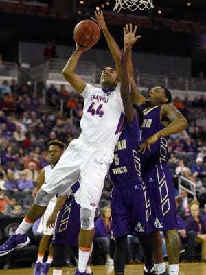 David Howard of University of Evansville is hit while releasing a shot against Maurice Howard (5) and Marquis Vance of Alcorn State during the first half of the game at the Ford Center in Evansville Monday.