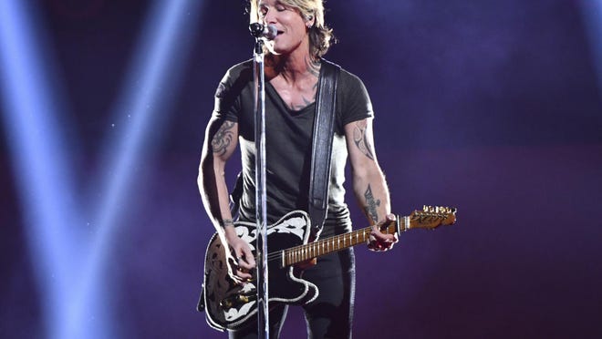 Keith Urban performs "Never Comin' Down" at the 52nd annual CMA Awards at Bridgestone Arena on Wednesday, Nov. 14, 2018, in Nashville, Tenn.