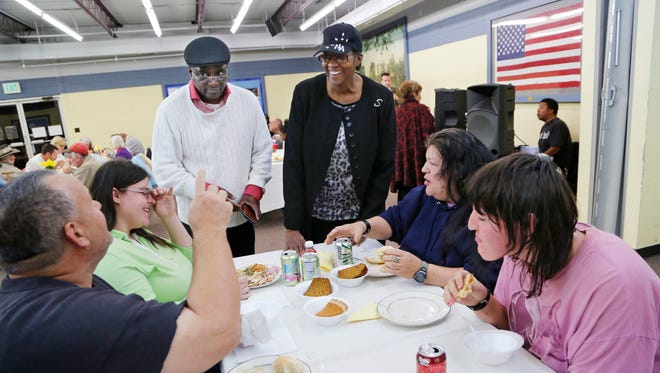 Pastor Dale Draper and his wife Starla meet with Charles Pierce, from left, Paula Harris, Kimberly Thompson and Kim Harris during Thanksgiving dinner Tuesday, November 24, 2015, at the Center @ Jenks Rest in Columbian Park. The Drapers, from Greater Macedonia Church, organized the dinner. The Drapers are committed to sheltering and caring for the homeless and less fortunate in this community.