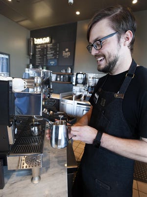 Peet's Coffee shift leader David Jennings makes a latte at the Sudbury shop shortly after its opening in 2018.
