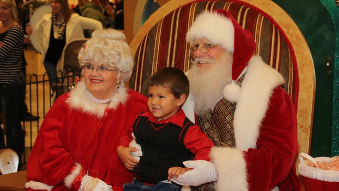 Skyler Romero, 3, was the first person to sit on Santa's lap after his arrival at Cordova Mall last November. Santa Claus and his elves will return to Cordova Mall on Friday