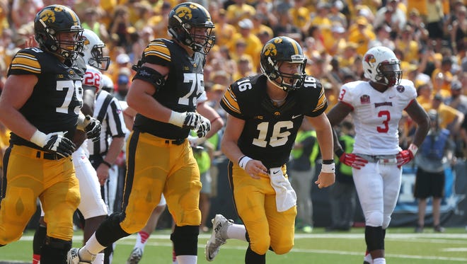 Ike Boettger (75) has gone from playing quarterback in high school to protecting quarterback C.J. Beathard as Iowa's starting right offensive tackle.