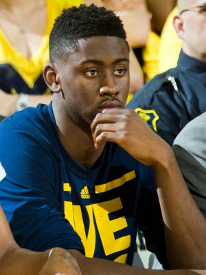 Michigan's Caris LeVert watches from the bench  against Michigan State on Feb. 6, 2016, at the Crisler Center in Ann Arbor.