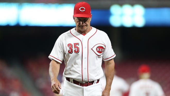 Cincinnati Reds interim manager Jim Riggleman (35) walks back to the dugout after a pitching change in the seventh inning during a National League baseball game between the New York Mets and the Cincinnati Reds, Tuesday, May 8, 2018, at Great American Ball Park in Cincinnati. Cincinnati won 7-2. 