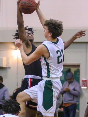 Catholic's Luke Stringfellow (21) and West Florida's Keion Burrell (10) take the opening tipoff during their semifinal game of the 6th annual Crusader Classic at Catholic High School on Thursday, December 28, 2017. Catholic won 48-31 and will face Pine Forest in the championship game on Friday.