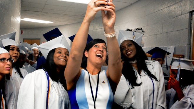 Helen Thackston Charter School principal Melissa Achuff takes a selfie with Carlyse Taylor, left, and Morgan Crosby during the Helen Thackston Charter School commencement at Hannah Penn K-8 Friday, June 1, 2018. Bill Kalina photo