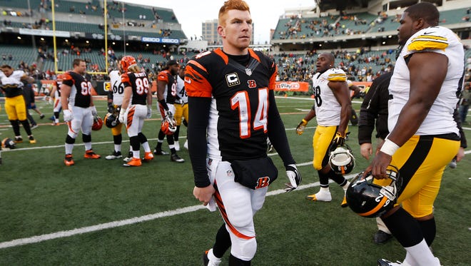 Bengals quarterback Andy Dalton walks off the field after Sunday's loss to the Steelers.